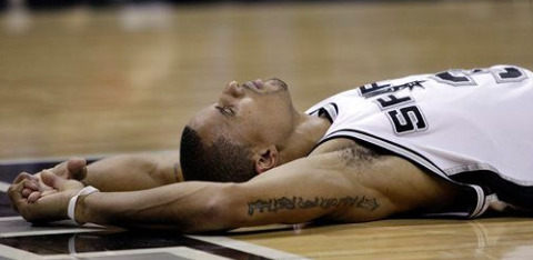 George Hill lies on the floor of the AT&T Center during the Spurs' 107-101 loss in Game 4 to the Phoenix Suns